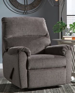 Ashley Nerviano manual recliner with plush fabric upholstery and cushioned armrests, shown in a cozy living room setting.