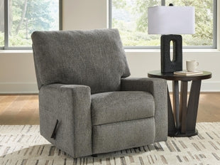 Ashley Newellen manual recliner in neutral fabric, showing a closed position with plush cushioning and a wooden base.