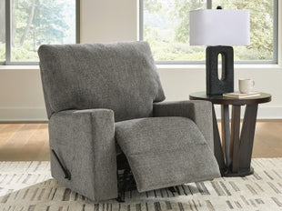 Ashley Newellen manual recliner shown in open position with plush upholstery and wooden legs, angled view highlighting its comfort and style.