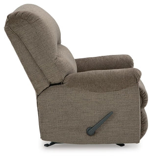 Ashley Stonemeade manual rocker recliner with cushioned seat and back, shown from the side in a cozy living room setting.