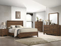 Brown cherry Crownmark Millie bedroom group with bed, dresser, and nightstands arranged in a stylish bedroom setting.