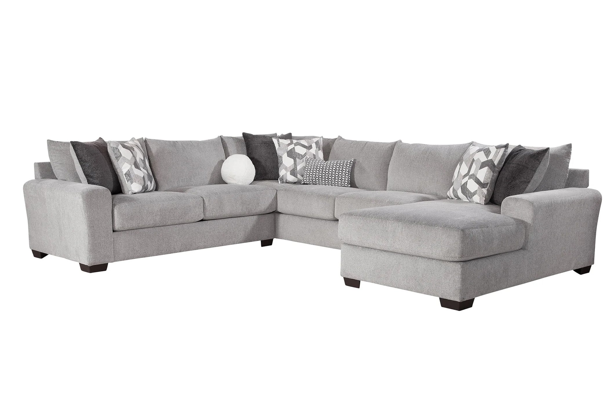 Light grey U-shaped sectional sofa by Behold with plush cushions and modern design, shown in a stylish living room setting.