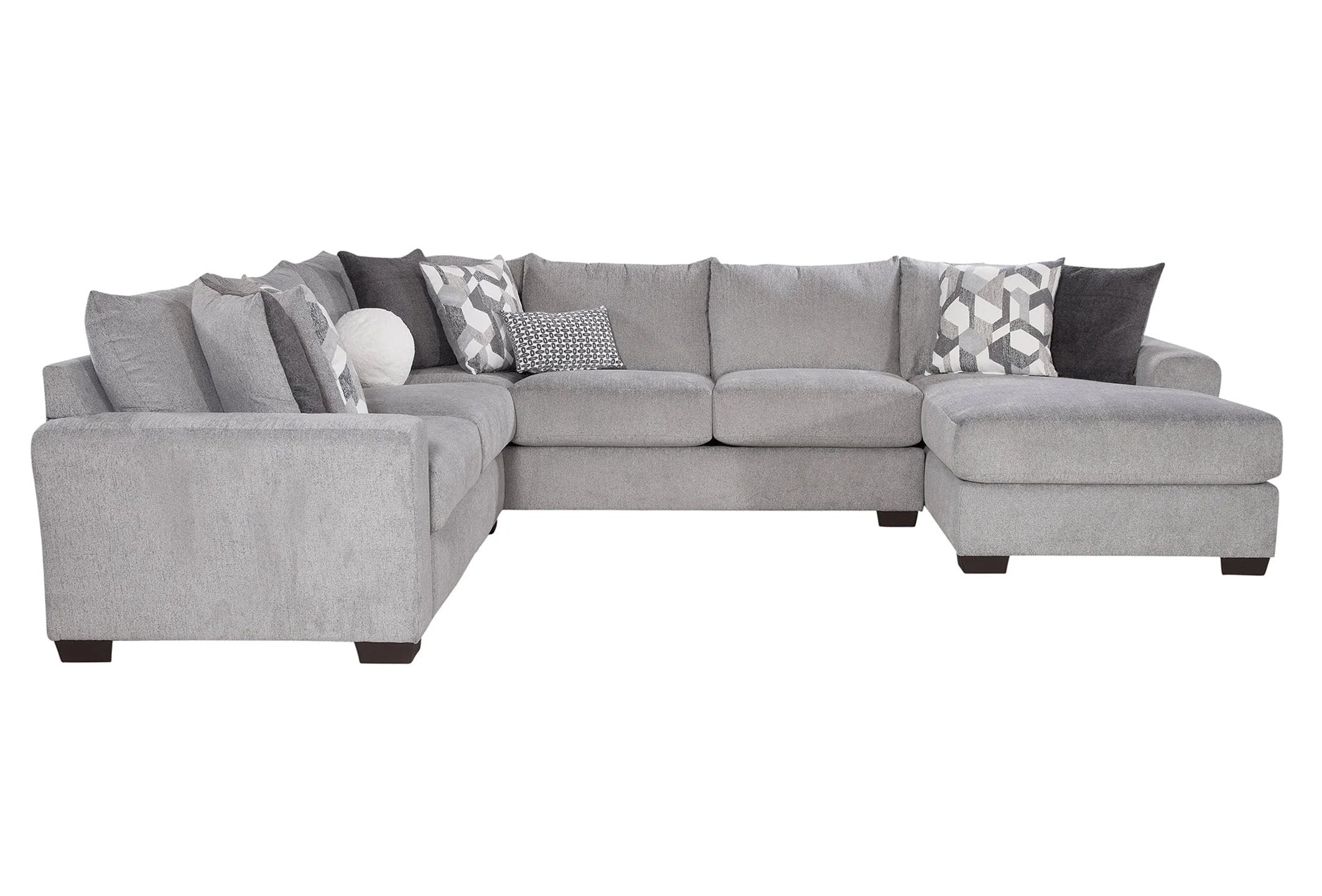 Light grey U-shaped sectional sofa by Behold, showcasing plush cushions and modern design in a stylish living room setting.