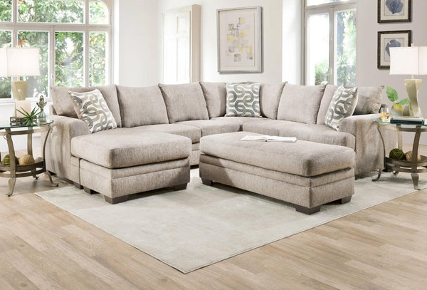 Cream U-shaped sectional sofa by Ashley with plush cushions and modern design, ideal for a spacious living room.