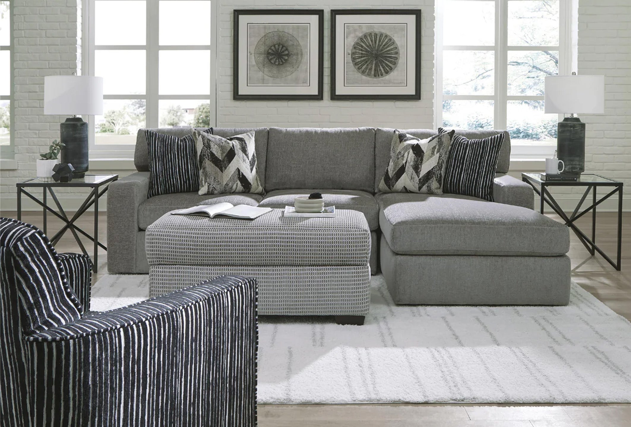 Grey Behold sofa chaise with plush cushions and modern design, perfect for a stylish living room seating area.