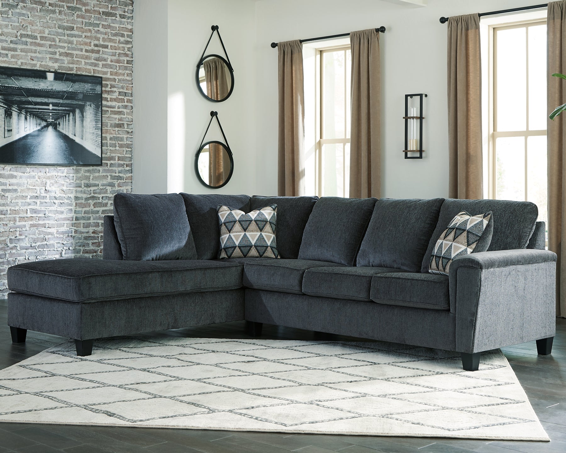 Slate grey Ashley L-shaped sectional sofa in a modern living room setting with plush cushions and stylish design.