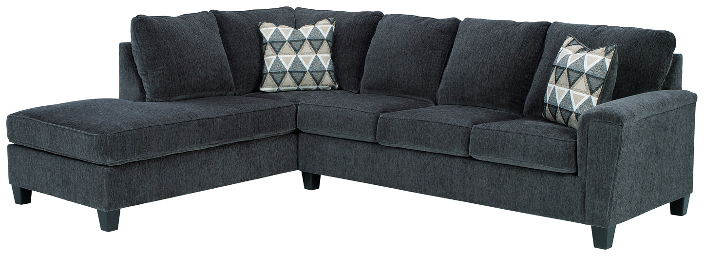 Slate grey Ashley L-shaped sectional sofa in a modern living room with plush cushions and sleek design.