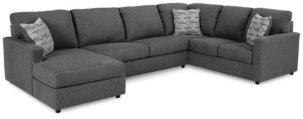 Charcoal grey Ashley U-shaped sectional sofa with plush cushions and modern design, shown in a stylish studio setting.