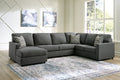 Charcoal grey U-shaped sectional sofa by Ashley with plush cushions and modern design in a stylish living room setting.