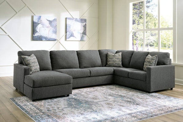Charcoal grey U-shaped sectional sofa by Ashley with plush cushions and modern design in a stylish living room setting.