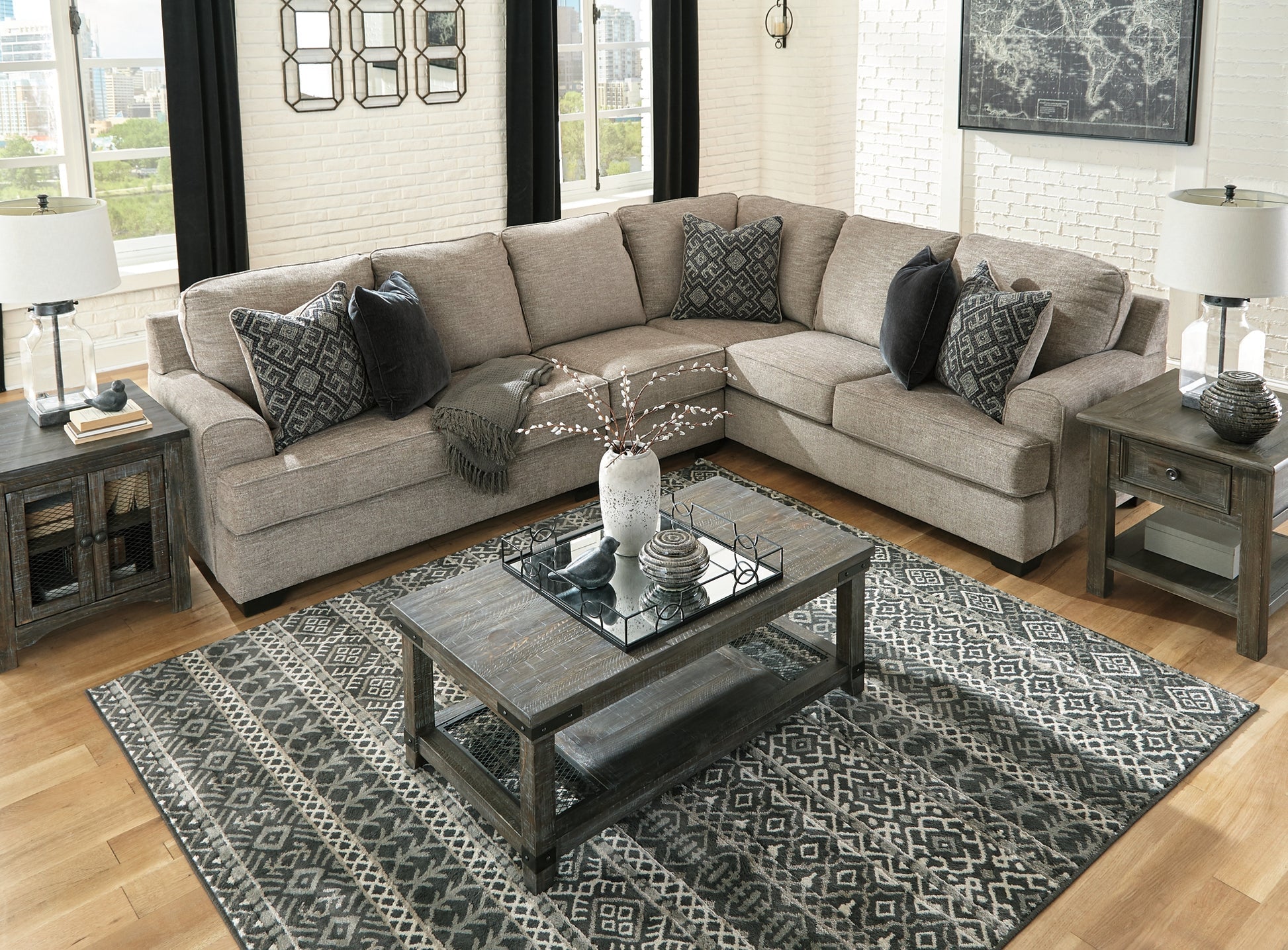 Brown Ashley L-shaped sectional sofa in a modern studio setting, showcasing plush cushions and spacious seating arrangement.