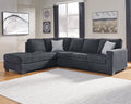 Slate grey Ashley L-shaped sectional sofa in a modern studio setting, showing plush cushions and sleek upholstery.