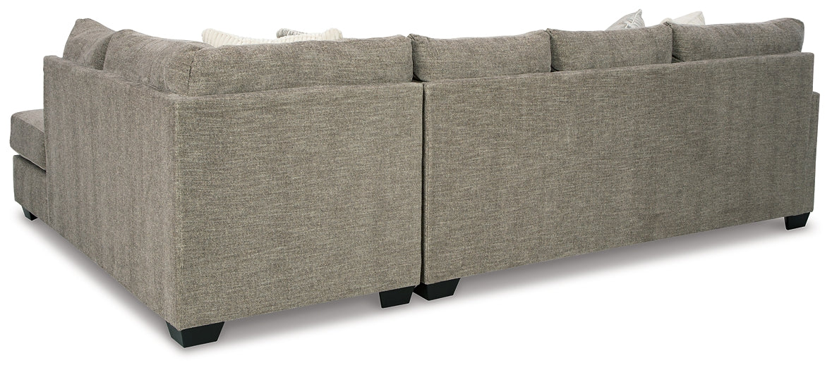 Beige Ashley U-shaped sectional sofa with plush cushions and modern design, shown in a stylish living room setting.