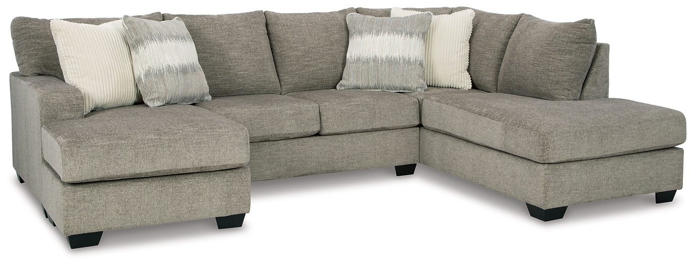 Beige U-shaped sectional sofa by Ashley, showing plush fabric and spacious design in a modern living room setting.