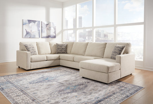 Cream U-shaped sectional sofa by Ashley with plush cushions and modern design, shown in a stylish living room setting.