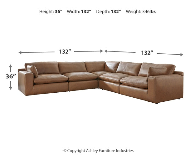 Five-piece genuine leather sectional sofa by Ashley, shown in a modern studio setting with plush cushions and sleek design.