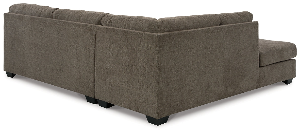 Brown Ashley L-shaped sectional sofa in a modern studio setting, showcasing plush cushions and sleek design.