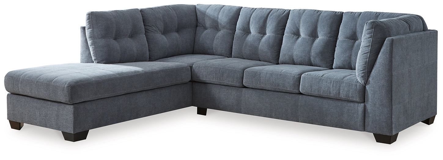Blue Ashley L-shaped sectional sofa in a modern living room with plush cushions and a contemporary design.