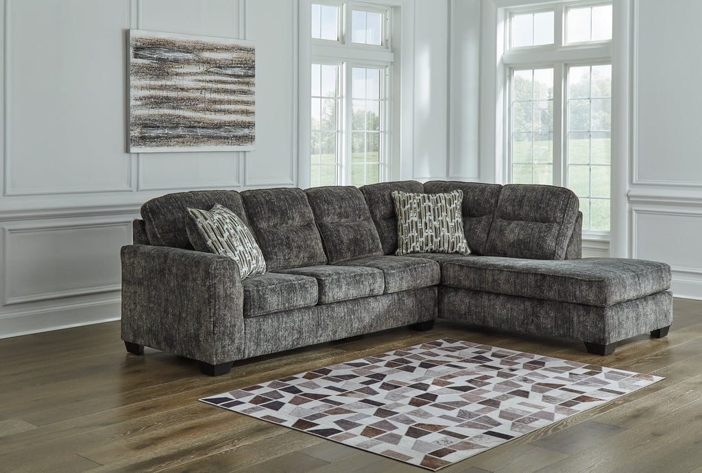Grey Ashley L-shaped sectional sofa with plush cushions and modern design, shown in a stylish living room setting.