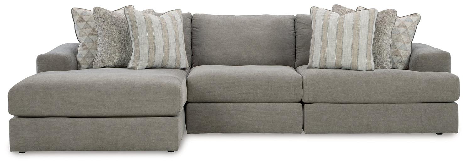 Grey Ashley sofa chaise with plush cushions and modern design, shown in a stylish studio setting.
