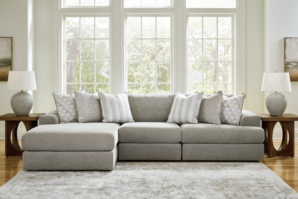 Ashley grey sofa chaise with plush fabric, modern design, and cushioned seating in a stylish living room setting.