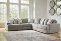 Grey Ashley L-shaped sectional sofa in a modern living room setting with plush cushions and fabric upholstery.