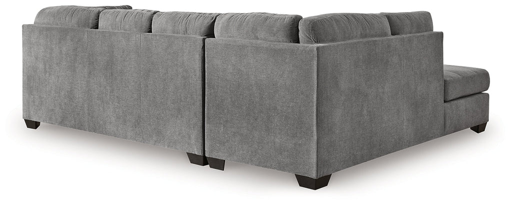 Grey Ashley L-shaped sectional sofa in a modern studio setting, showcasing plush cushions and spacious corner seating.