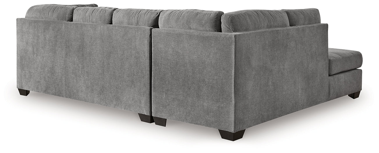 Grey Ashley L-shaped sectional sofa in a modern studio setting, showcasing plush cushions and spacious corner seating.