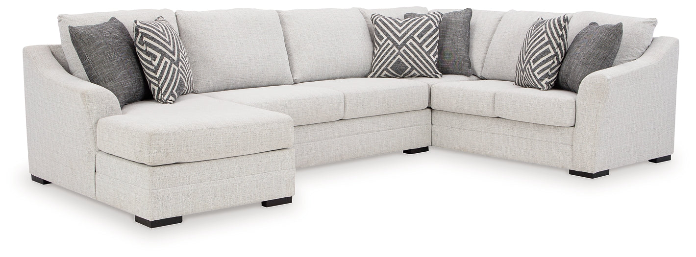 Ashley Off White U-shaped sectional sofa with plush cushions and modern design, shown in a stylish living room setting.