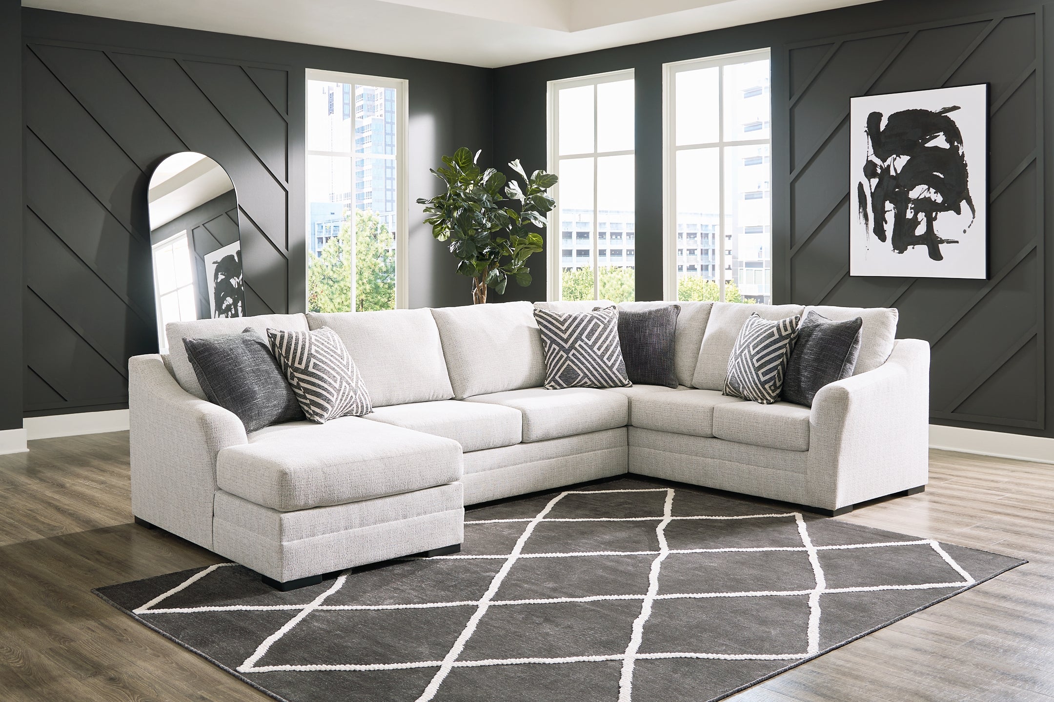 Ashley Off White U-shaped sectional sofa with plush cushions and modern design, shown in a stylish studio setting.