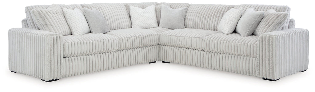 Ashley alloy corduroy L-shaped sectional sofa in a modern studio setting, showcasing plush fabric and spacious seating.