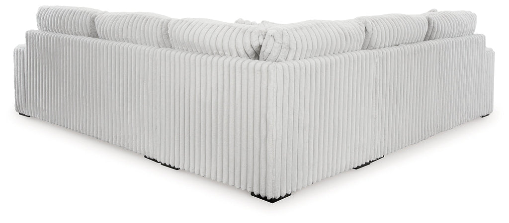 Ashley alloy corduroy L-shaped sectional sofa with plush cushions and modern design, shown in a stylish studio setting.