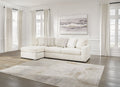 Ivory Ashley sofa chaise with plush cushions and wooden legs, styled in a modern living room setting.