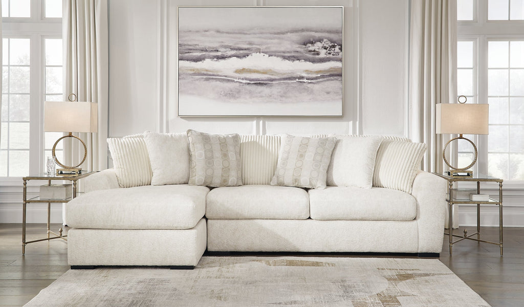 Ivory Ashley sofa chaise with plush cushions and wooden legs, shown in a modern living room setting.