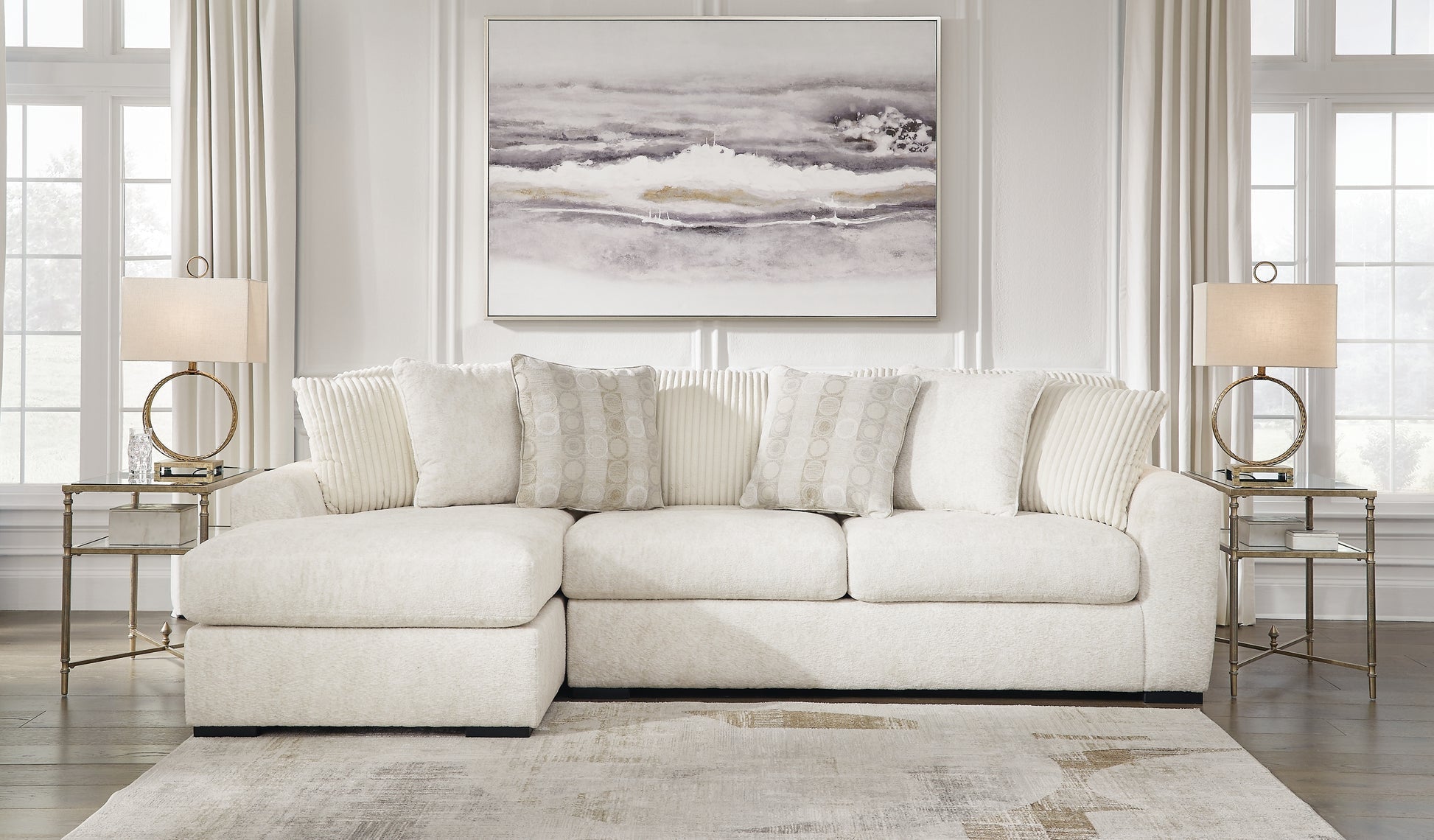 Ivory Ashley sofa chaise with plush cushions and wooden legs, shown in a modern living room setting.