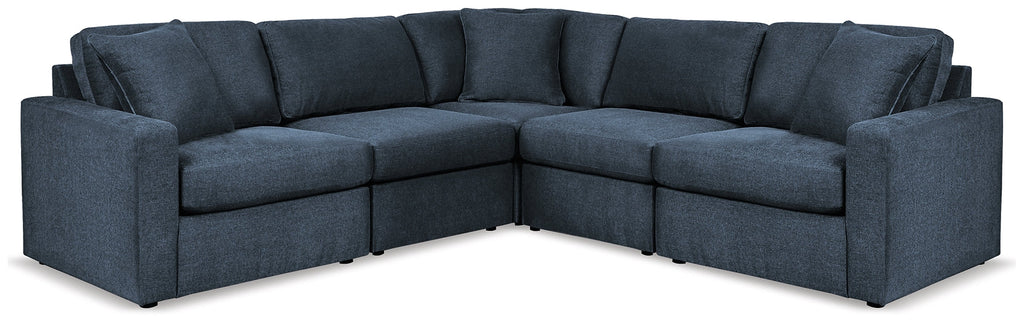 Blue Ashley modular L-shaped sectional sofa in a modern studio setting with plush cushions and sleek design.