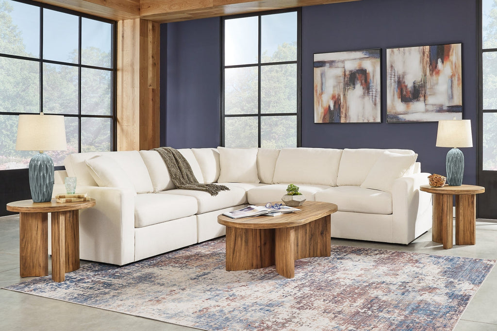 Cream Ashley modular L-shaped sectional sofa in a modern studio setting with plush cushions and sleek design.