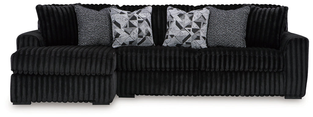 Black corduroy sofa chaise by Signature Design Ashley featuring plush fabric and a modern, comfortable lounge design.