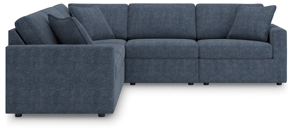 Blue Ashley modular L-shaped sectional sofa with plush cushions and modern design, shown in a stylish living room setting.