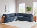 Blue Ashley modular L-shaped sectional sofa with plush cushions in a modern studio setting.