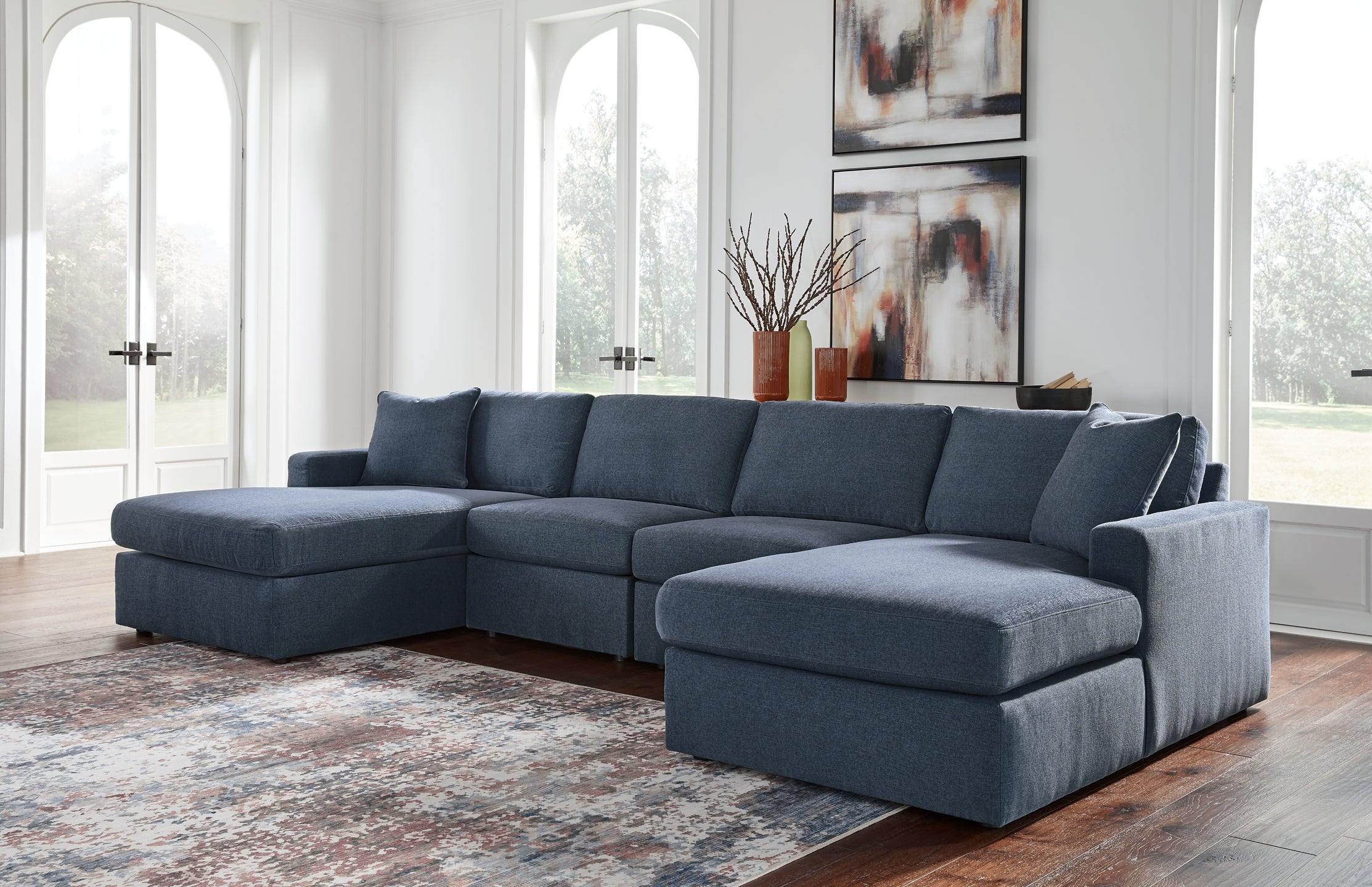 Blue Ashley modular U-shaped sectional sofa with plush cushions and modern design, shown in a stylish living room setting.