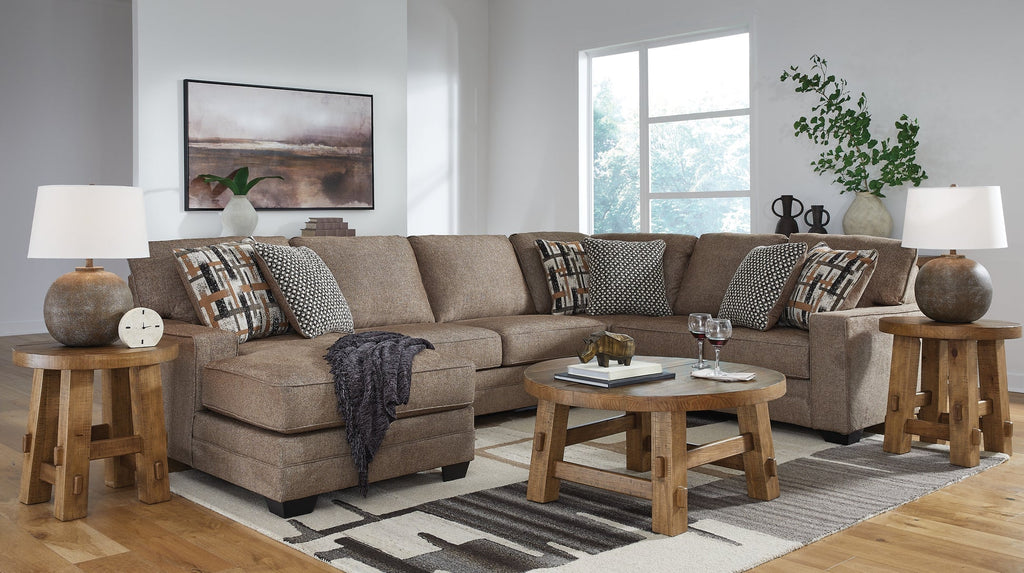 Brown Ashley U-shaped sectional sofa in a stylish living room setting, featuring plush cushions and modern design.