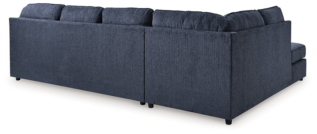 Blue U-shaped sectional sofa by Ashley, showing plush cushions and spacious U-shape arrangement in a modern living room setting.