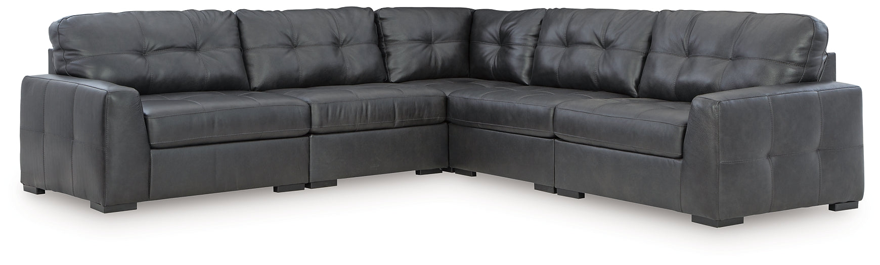 Black genuine leather L-shaped sectional sofa by Ashley, shown in a modern studio setting with plush cushions and sleek design.