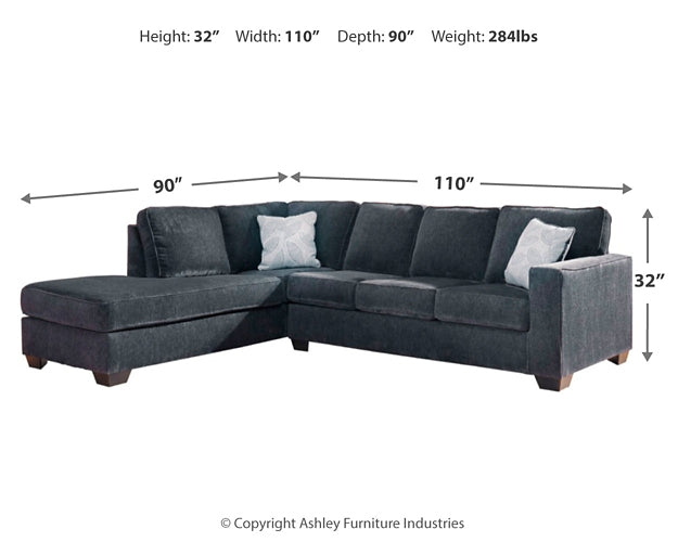 Slate grey L-shaped sleeper sectional by Ashley, showcasing plush cushions and modern design in a stylish studio setting.