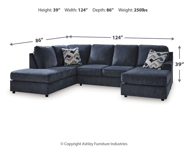 Blue U-shaped sectional sofa by Ashley in a modern living room setting, showcasing plush cushions and spacious U-shaped design.