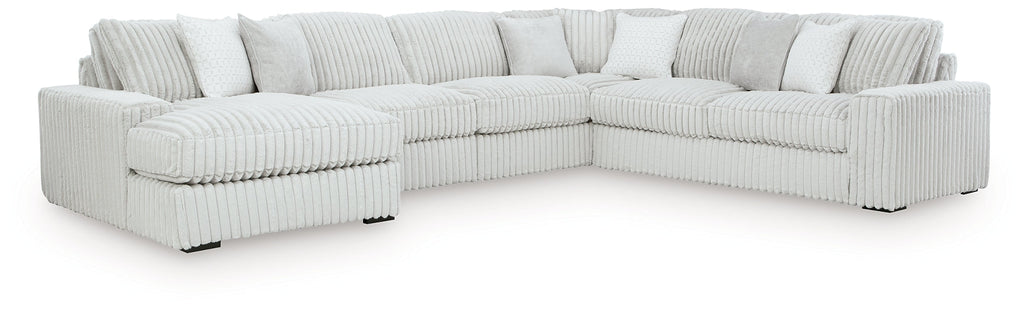 Ivory corduroy U-shaped sectional sofa by Ashley, showing plush cushions and modern design in a studio setting.