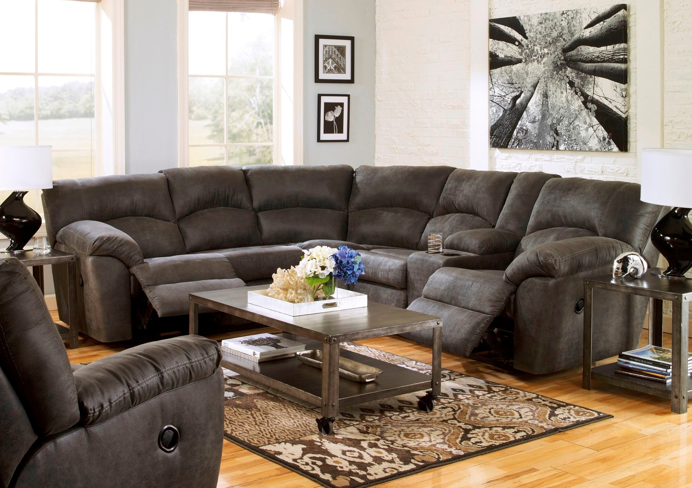 Ashley faux leather reclining sectional in pewter, featuring plush cushions and reclining seats for comfortable living room seating.